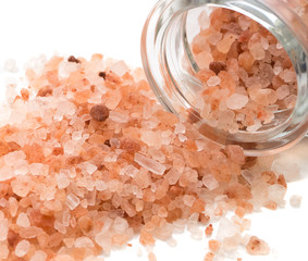 Fototapeta na wymiar Medical salt in glass jar on white background. Pink Himalayan salt in a jar. Big crystals in glass pot for kitchen and beauty
