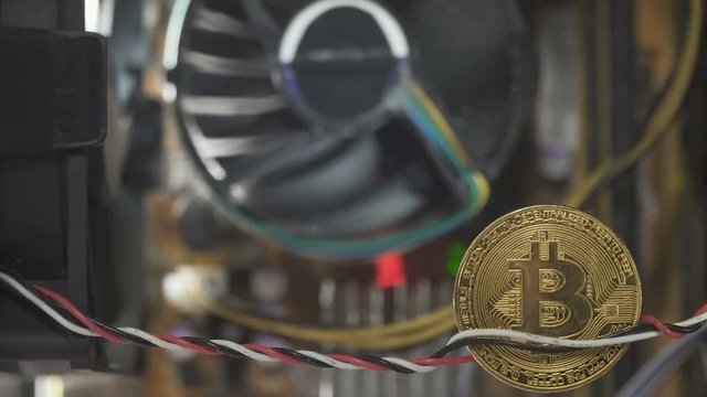 Coin of bitcoin between computer wires