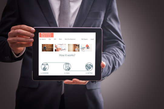 Real Estate Agent Man Showing A Tablet