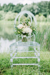 wedding bouquet on the glass chair, outdoor, fine art.