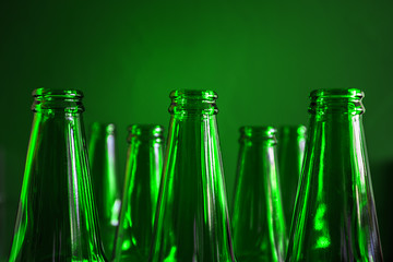 Conceptual beer background. Green beer bottles on a green background