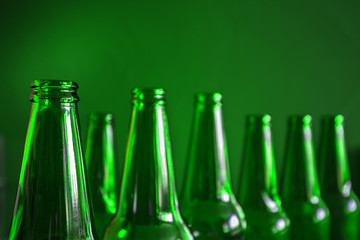 Conceptual beer background. Green beer bottles on a green background