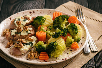 Pork tenderloin baked with blue cheese and stewed vegetables.
