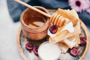 Fresh homemade crepes. Russian pancakes with honey