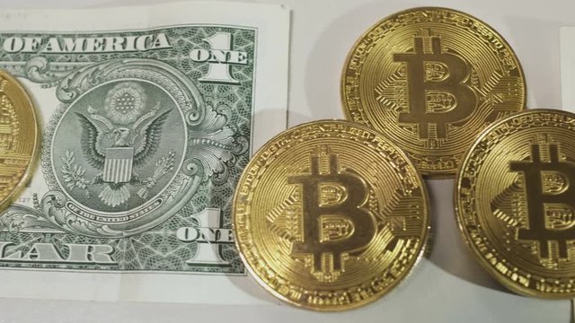 Golden bitcoins on dollars