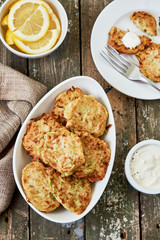 Zucchini fritters, vegetarian zucchini pancakes and yogurt sauce, top view. Healthy, vegetarian food