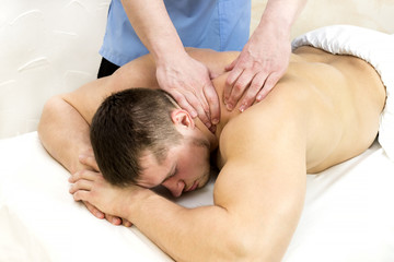 Obraz na płótnie Canvas The process of sports massage is done by a man in a massage salon 