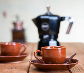 Obraz na płótnie Canvas Cups of coffee and a coffee pot on a rural table