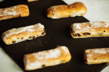 Strudel Apple and sugar powder. Biscuit from the puffed Test on the Gray Background. Dessert with Fruits.Copy space for Text. selective focus.