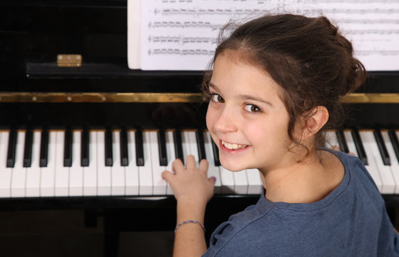 Young girl and piano - Powered by Adobe
