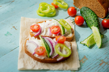 Sandwich with herb pesto and edible nasturtium flowers