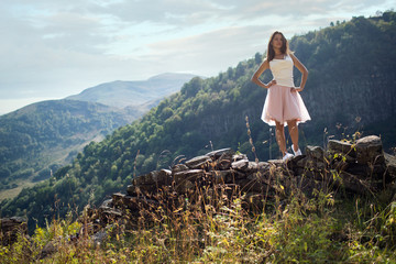 Naklejka premium Young woman near a stone wall