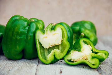 Photo of sliced colorul peppers over wooden table