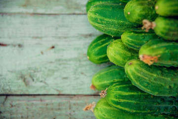 Pile of fresh organic cucumbers on a market