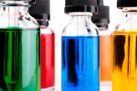 transparent glass bottles filled colored liquid with dropper