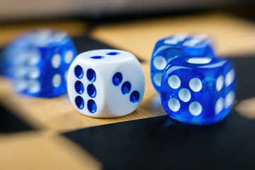 blue and white dices on chessboard with blur effect