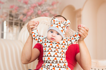 Adorable Caucasian baby and his father. Portrait of a three months old baby boy