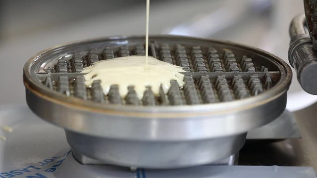 waffle mix pouring into vintage metal waffle maker