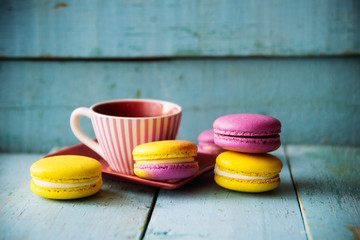 Gentle colorful macaroons on color wooden background