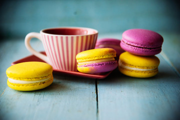 Gentle colorful macaroons on color wooden background