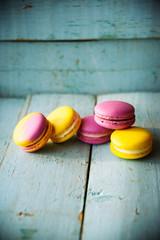 Gentle colorful macaroons on color wooden background