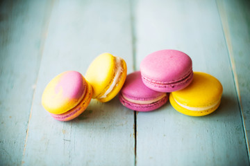Group of pastel color macaroons on blue textured shabby chic background, with room for copy space