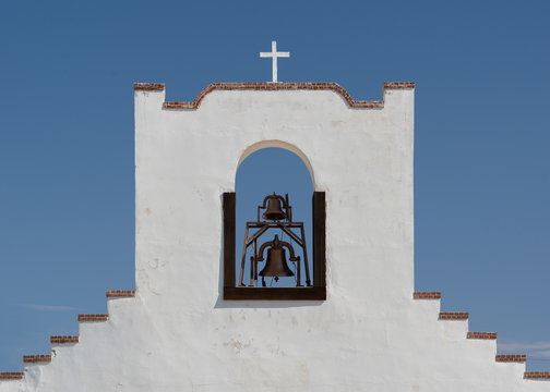 Cross and bell tower of the Socorro Mission in El Paso, Texas