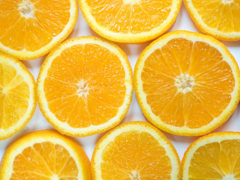 Abstract background with citrus-fruit of orange slices. Close-up.