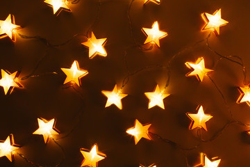 Star shaped Christmas lights. Holiday pattern. Flat lay, top view
