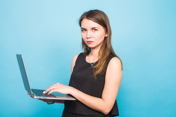Smart beautiful young woman using laptop pc computer isolated on blue background
