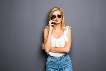 Naklejka premium Woman phone talking portrait. Gray background isolated. Female model.