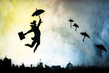 man is flying with an umbrella