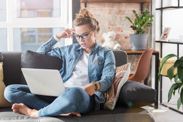 Serious girl working at notebook computer