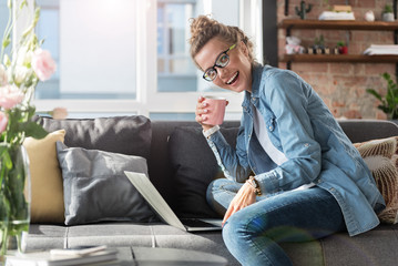 Hilarious smiling young lady at home