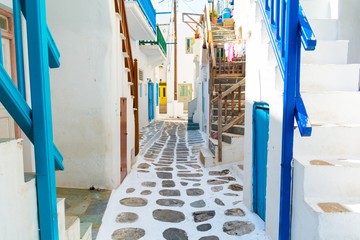 typical whitewashed narrow street in Mykonos island, Cyclades, Greece © lukaszimilena