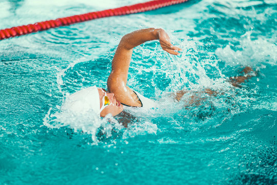 Female swimmer on training in the swimming pool.