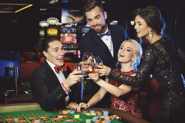 People celebrating their win after successful game in the casino