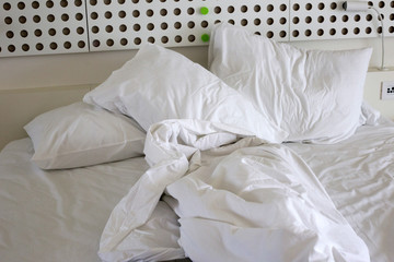 Fototapeta na wymiar Unmade bed in hotel room