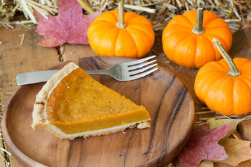Slice of Pumpkin Pie on a Wooden Plate