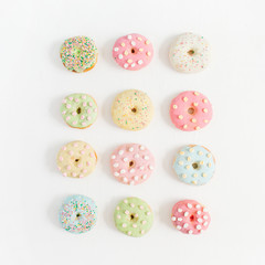 Obraz premium Colorful donuts. Flat lay, top view minimal pattern.