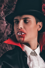  handsome man dressed in a Dracula costume for Halloween. 