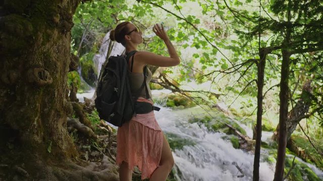 Woman drinking water in Plitvice Lakes National Park
