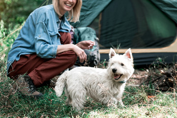 Carefree girl having fun with pet in forest