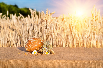 bread bun with sesame seeds lying on a table