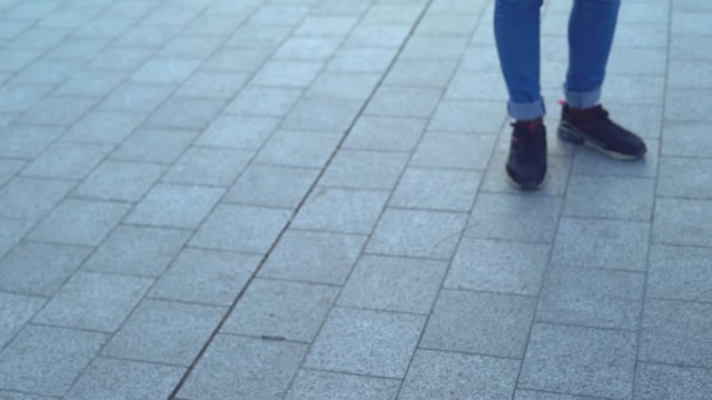 young attractive woman on a bridge on the river bank. modern extreme dances in the style of hip-hop and classical ballet. the girl rhythmically moves to the music. The girl uses a handrail as a dance