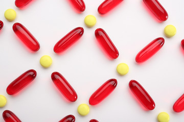 Composition with colorful pills on white background