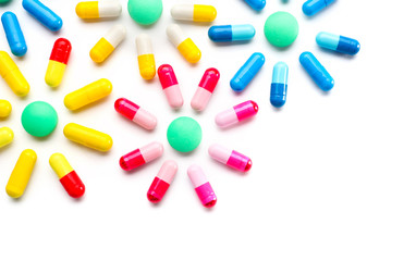 Composition with colorful pills on white background