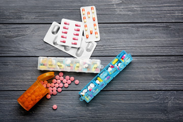 Composition with different pills on wooden background