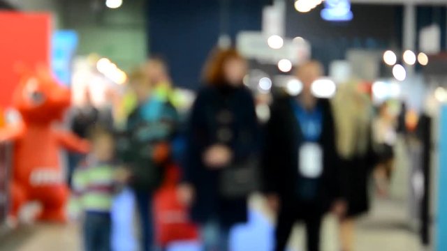 Abstract Defocused Blurred Background flow of many people inside space shopping center or mall, exhibition, exposition, hall real time.