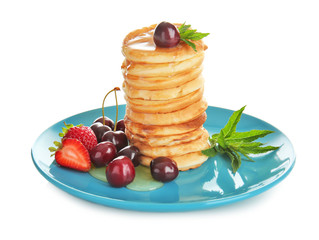 Plate with tasty pancakes and berries isolated on white
